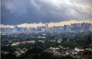 dramatic clouds over business district, metaphor for Philippine economic storm"