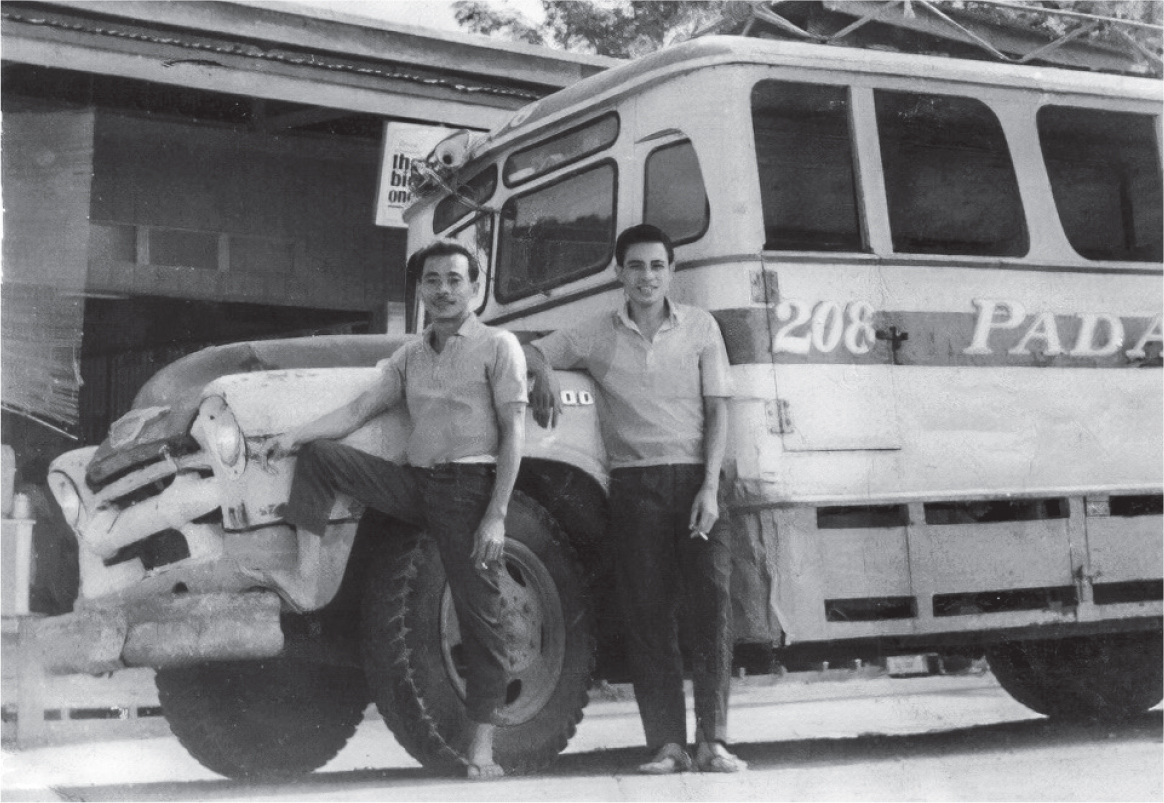 Black-and-white photo of Nicanor "Momoy" Gabunada Sr. and his bus conductor leaning against the front of their passenger bus, number 208.